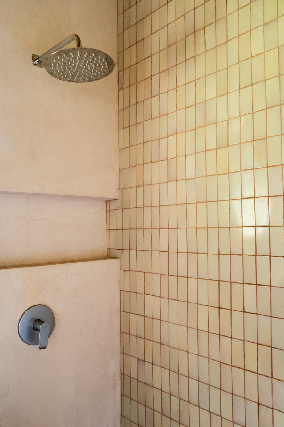 Bathroom detail showing concrete shower and tiling