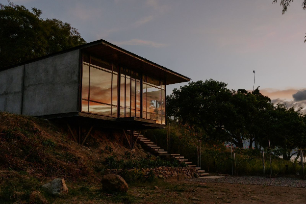 Estudio Sibaque steel frame construction on a hillside site at Lake Atitlán with floor-to-ceiling windows