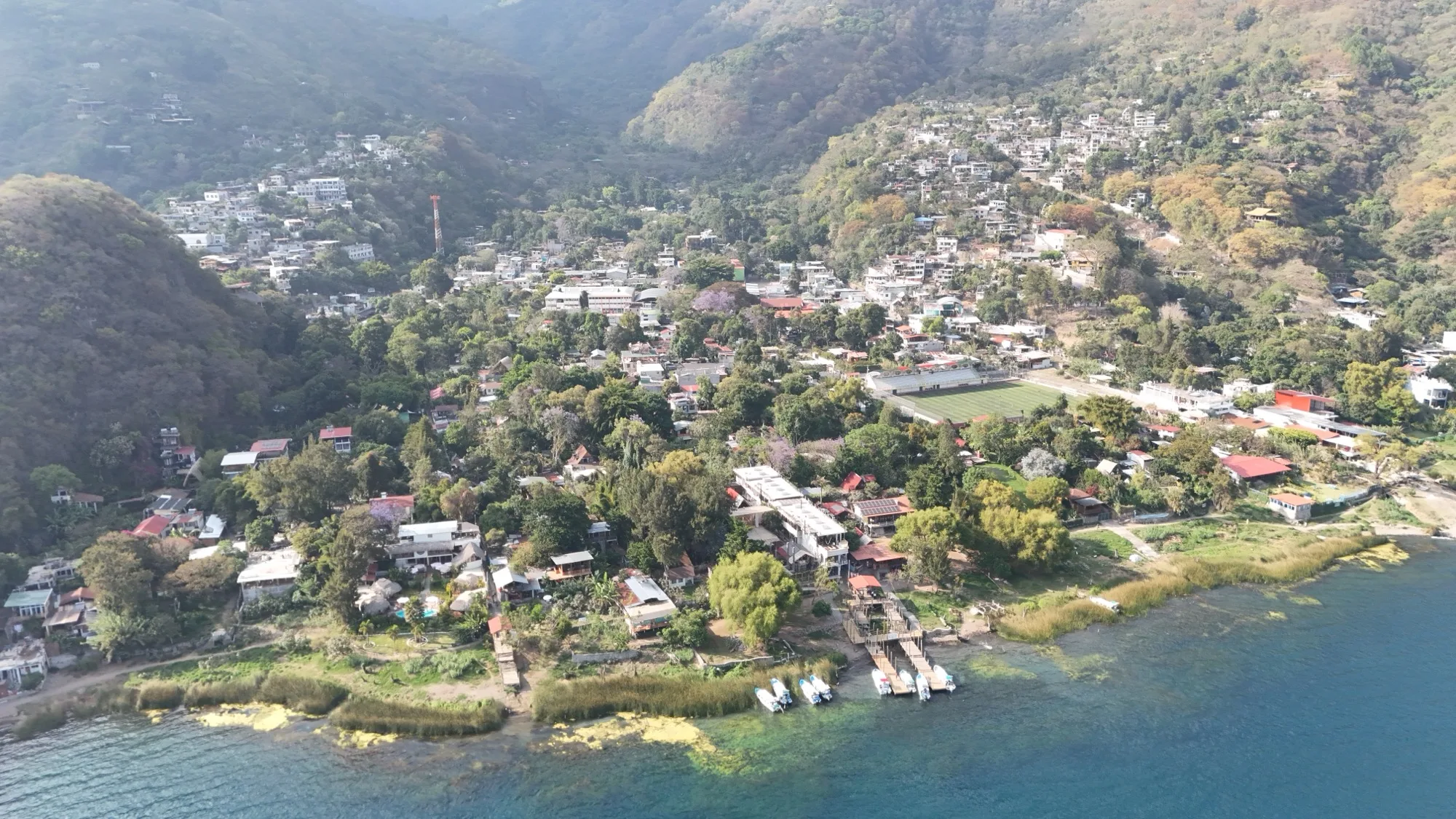 Boat docks along the San Marcos La Laguna shoreline — the primary access point for many of the village's lakefront properties